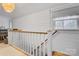 Upstairs hallway featuring paneled walls, natural light and hardwood floors at 514 3Rd Avenue Se Dr, Hickory, NC 28602