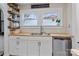 Well-lit kitchen featuring butcher block counters, a stainless-steel dishwasher, and a stainless-steel sink at 514 3Rd Avenue Se Dr, Hickory, NC 28602