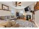 Inviting living room with hardwood floors, a fireplace, and a spacious gray sectional sofa at 514 3Rd Avenue Se Dr, Hickory, NC 28602