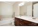 Bright bathroom with double vanity, dark cabinets, and a shower/tub combination at 5425 Closeburn Rd # 309, Charlotte, NC 28210
