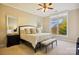 Serene primary bedroom with large window, neutral color scheme, and bench at the end of the bed at 5425 Closeburn Rd # 309, Charlotte, NC 28210