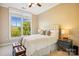 Comfortable bedroom with tufted headboard, side tables with lamps, a large window, and natural light at 5425 Closeburn Rd # 309, Charlotte, NC 28210