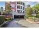 Secured parking garage entrance for residents with mature trees surrounding the building at 5425 Closeburn Rd # 309, Charlotte, NC 28210