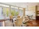 Sun-filled living room with expansive windows, hardwood floors, comfortable seating, and an open dining area at 5425 Closeburn Rd # 309, Charlotte, NC 28210