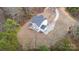 Aerial view of a new home featuring a long driveway, private wooded lot, and modern roof at 558 Edmunds Ln # 41, Clover, SC 29710