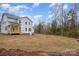 Expansive, newly-seeded backyard featuring a view of the home's rear exterior and surrounding woods at 558 Edmunds Ln # 41, Clover, SC 29710