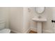 Charming powder room featuring a pedestal sink, classic fixtures, and a modern toilet at 558 Edmunds Ln # 41, Clover, SC 29710