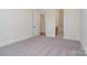Bedroom with neutral walls and carpet leading to the bathroom at 558 Edmunds Ln # 41, Clover, SC 29710