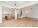 Bright open-concept living space with hardwood floors, adjacent to a modern kitchen and staircase at 558 Edmunds Ln # 41, Clover, SC 29710