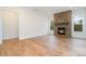 Spacious living room with hardwood floors, stone fireplace, and natural light from the windows at 558 Edmunds Ln # 41, Clover, SC 29710