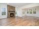 Inviting living room with stone fireplace, hardwood floors, and abundant natural light through large windows at 558 Edmunds Ln # 41, Clover, SC 29710