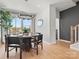 Dining room with a modern chandelier, large windows offering ample natural light, and sophisticated table setting at 5640 Kingspan Dr, Charlotte, NC 28217