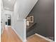 Hallway with hardwood floors, staircase, and neutral paint scheme, creating a welcoming transition space at 5640 Kingspan Dr, Charlotte, NC 28217