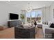 Cozy living room with a large TV, stylish furniture, and balcony access with natural light at 5640 Kingspan Dr, Charlotte, NC 28217