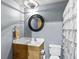 Bathroom with a vanity, toilet, round mirror and decorative shower curtain at 626 N Graham St # 211, Charlotte, NC 28202