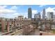Brick apartment building with city skyline views on a sunny day at 710 W Trade St # 309, Charlotte, NC 28202