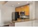 Bright kitchen featuring stainless steel appliances, wooden cabinetry, and granite countertops at 710 W Trade St # 309, Charlotte, NC 28202