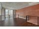 Bright living area with exposed brick wall, modern railings and hardwood floors at 710 W Trade St # 309, Charlotte, NC 28202