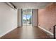 Open-concept living room featuring large windows, exposed brick, and hardwood floors at 710 W Trade St # 309, Charlotte, NC 28202