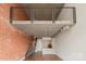 Modern living room with loft features exposed brick, staircase, and open-concept kitchen at 710 W Trade St # 309, Charlotte, NC 28202