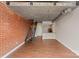Modern living room with loft features exposed brick, staircase, and open-concept kitchen at 710 W Trade St # 309, Charlotte, NC 28202