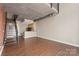 Open-concept living room featuring concrete ceiling, duct work, staircase, and kitchen at 710 W Trade St # 309, Charlotte, NC 28202