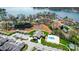 Aerial view of a lakeside property featuring a community pool, pond, and lush landscaping at 8146 Viscount Ct, Denver, NC 28037