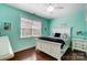 Bright bedroom with aqua walls, a ceiling fan, and large windows at 8146 Viscount Ct, Denver, NC 28037