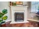 Close-up of a cozy fireplace with a decorative screen and elegant mantel at 8146 Viscount Ct, Denver, NC 28037