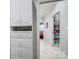 Hallway with linen closet, storage cabinets and shelves on ceramic tile floor at 8146 Viscount Ct, Denver, NC 28037