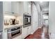 Kitchen with stainless steel appliances and wood flooring, adjacent to hallway at 8146 Viscount Ct, Denver, NC 28037