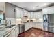 Well-lit kitchen features stainless steel appliances, granite countertops, and white cabinetry at 8146 Viscount Ct, Denver, NC 28037