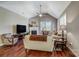 Bright living room featuring hardwood floors, a fireplace, and a ceiling fan at 8146 Viscount Ct, Denver, NC 28037