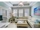 Bright living room with tile floors and a plush white sectional sofa at 8146 Viscount Ct, Denver, NC 28037