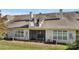 Rear exterior of the home features a screened-in porch, multiple windows, and a rooftop deck with railings at 8534 Loxton Cir, Charlotte, NC 28214