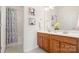 Bright bathroom featuring double sinks, decorative towels, and a shower/tub combo at 8534 Loxton Cir, Charlotte, NC 28214