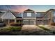 Charming townhome showcasing a well-manicured lawn, private garage, and appealing architectural details at 8534 Loxton Cir, Charlotte, NC 28214