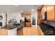 A modern kitchen with granite countertops, stainless steel appliances, and wood cabinets at 8534 Loxton Cir, Charlotte, NC 28214