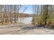 Scenic view of the lake access point with a concrete ramp, wooden docks, and lush trees at 8534 Loxton Cir, Charlotte, NC 28214