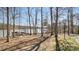 Picturesque view of the lake featuring a wooden boardwalk, a picnic area, and wooded scenery at 8534 Loxton Cir, Charlotte, NC 28214