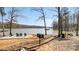 Lakefront featuring lakeside patio with chairs, dock and grill area at 8534 Loxton Cir, Charlotte, NC 28214