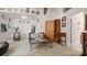 Cozy living room with hardwood furniture, a PacMan arcade game, and comfortable leather seating at 8534 Loxton Cir, Charlotte, NC 28214