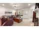 Cozy living room with a large sectional, natural light, and a neutral color palette at 8534 Loxton Cir, Charlotte, NC 28214