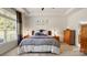 Comfortable primary bedroom with a large window, tray ceiling, and neutral colors at 8534 Loxton Cir, Charlotte, NC 28214