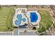 Aerial view of the community pool area featuring multiple pools, splash pad, playground, and parking at 8534 Loxton Cir, Charlotte, NC 28214