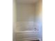 A bathtub with a tile surround is ready to be filled with bubbles and enjoyed at 9450 Paul Payne Store Rd, Stony Point, NC 28678
