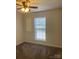 A bedroom with carpet, overhead lighting, a closet, and a big window for natural light at 9450 Paul Payne Store Rd, Stony Point, NC 28678