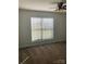 This cozy carpeted bedroom has a ceiling fan and big window for lots of light at 9450 Paul Payne Store Rd, Stony Point, NC 28678