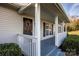 Inviting front porch with decorative wreath, white pillars, and neat landscaping at 9450 Paul Payne Store Rd, Stony Point, NC 28678