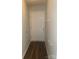 A hallway with wood floors leads to a white door, ready for a new owner to enjoy at 9450 Paul Payne Store Rd, Stony Point, NC 28678
